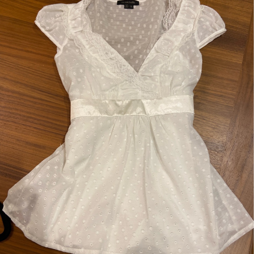 white polka-dot blouse, sheer with attached tank top. Satin tie detail